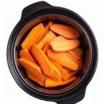 Put raw thinly sliced sweet potatoes in a slow cooker with these 4 ingredients. You’ll never eat them another way.